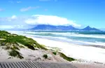 Big Bay Beach - a huge stretch of white sand where flowers line the dunes behind the beach and out to sea the view is spectacular