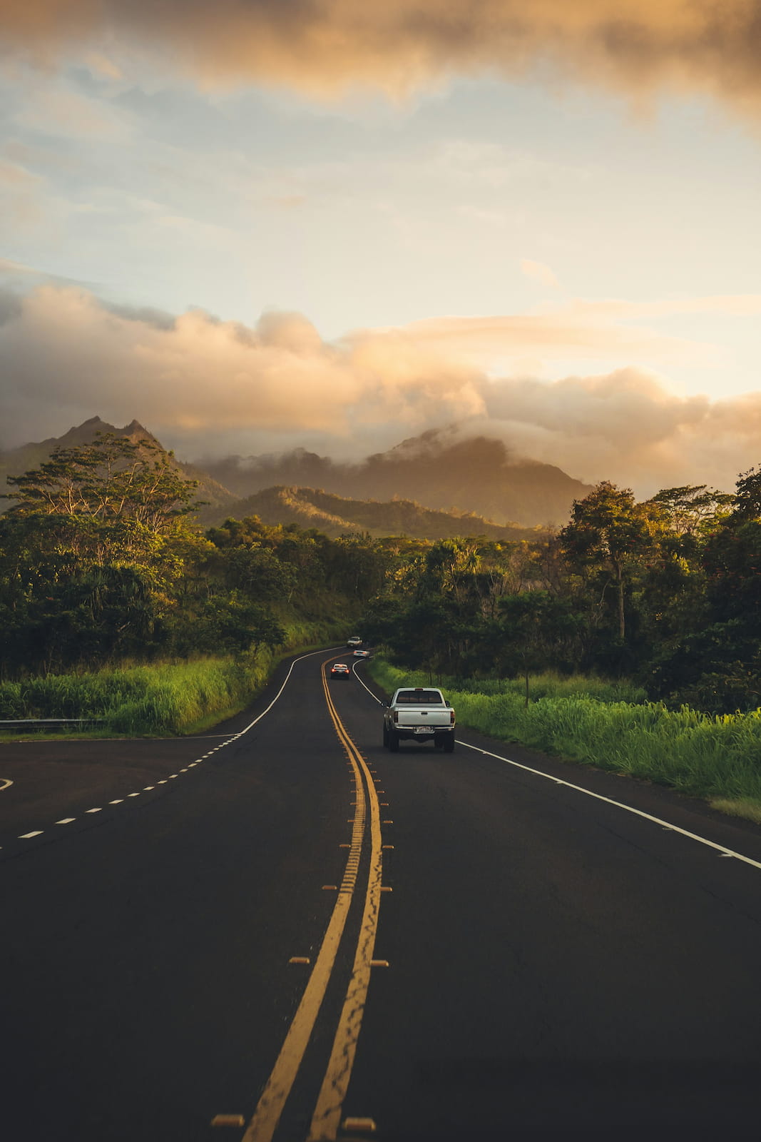 Kauai is just about the best Hawaiian island to visit if you're looking for stunning sunset hikes View of the freeway surrounded by jungle at sunset on Kauai, Hawaii