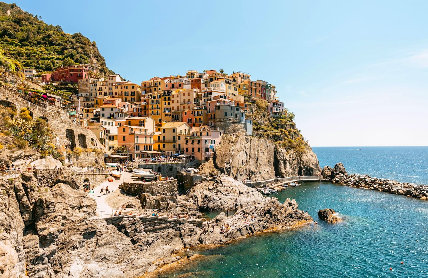 View of the town of Manarola. Deciding when to visit Cinque Terre depends on a couple factors, and different seasons may be best for different people. View of the Cinque Terre town of Manarola, Italy
