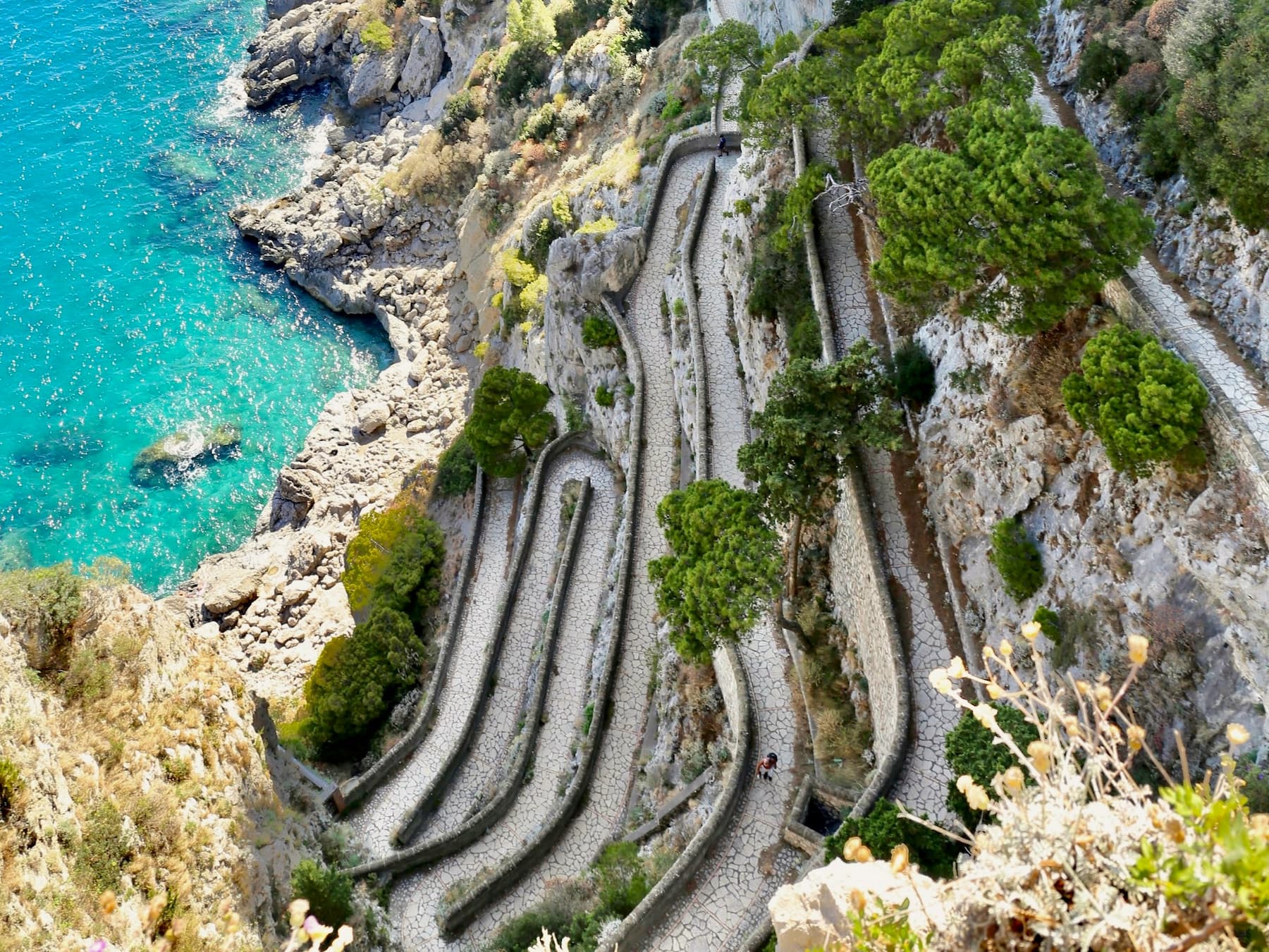 Looking down at the pathway of Via Krupp, one of the most famous places to visit on the Capri map